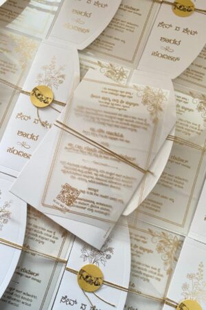 Transparent card with off white cover, gold paper tag