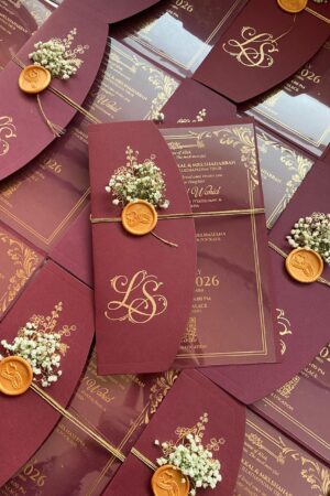 Transparent card with maroon color, fresh flower and wax seal